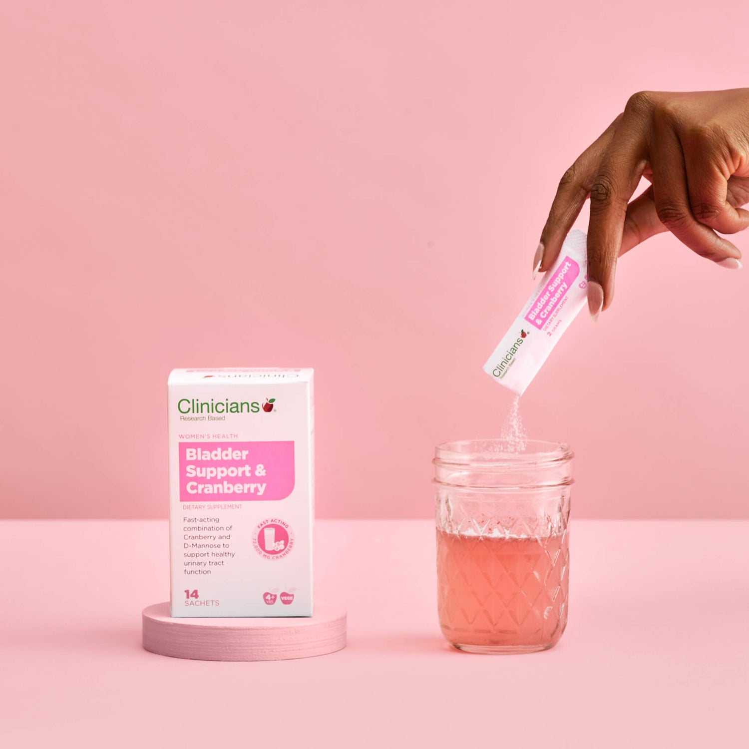 Packet of Bladder Support & Cranberry next to a glass of water
