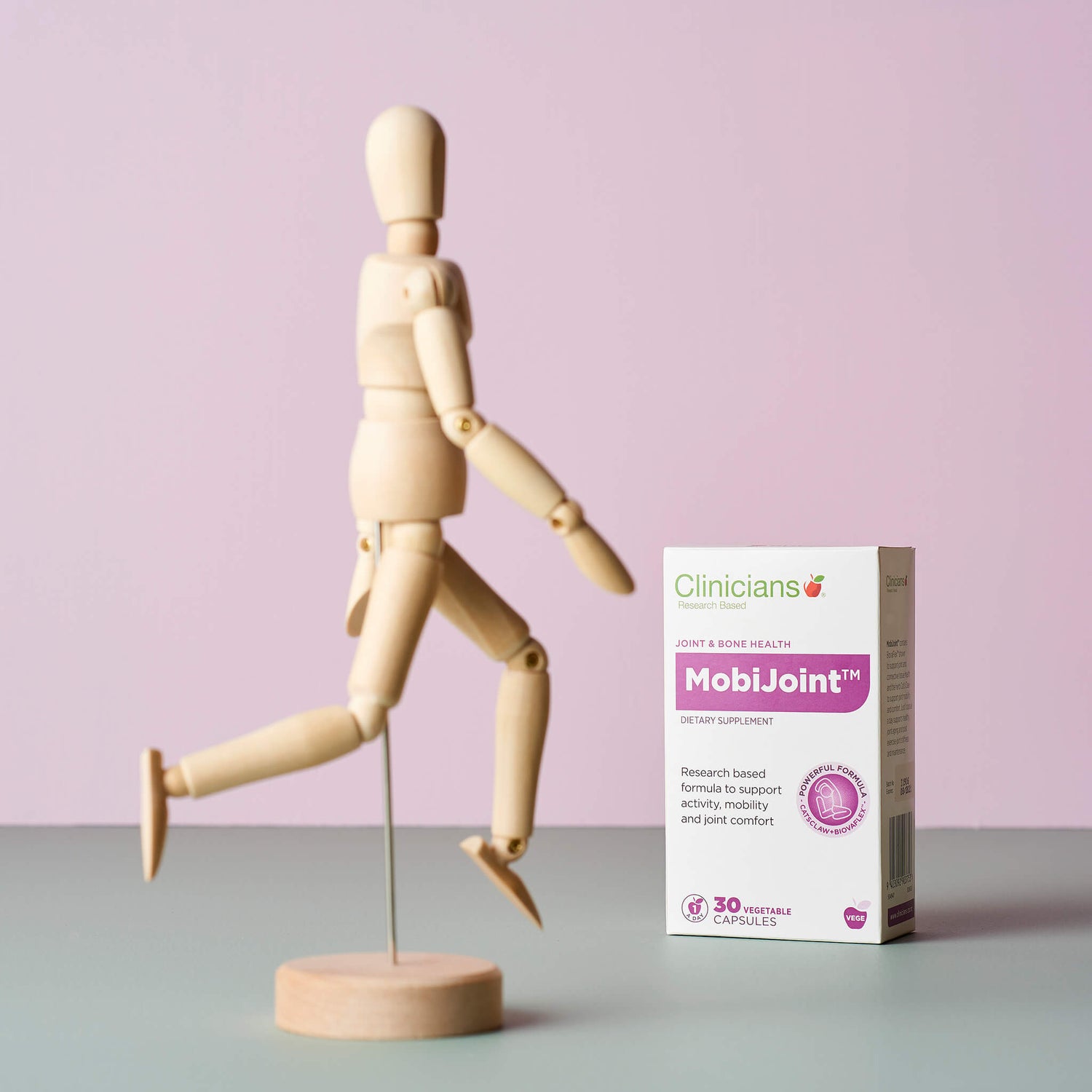 Product packaging next to miniature wood model of human body