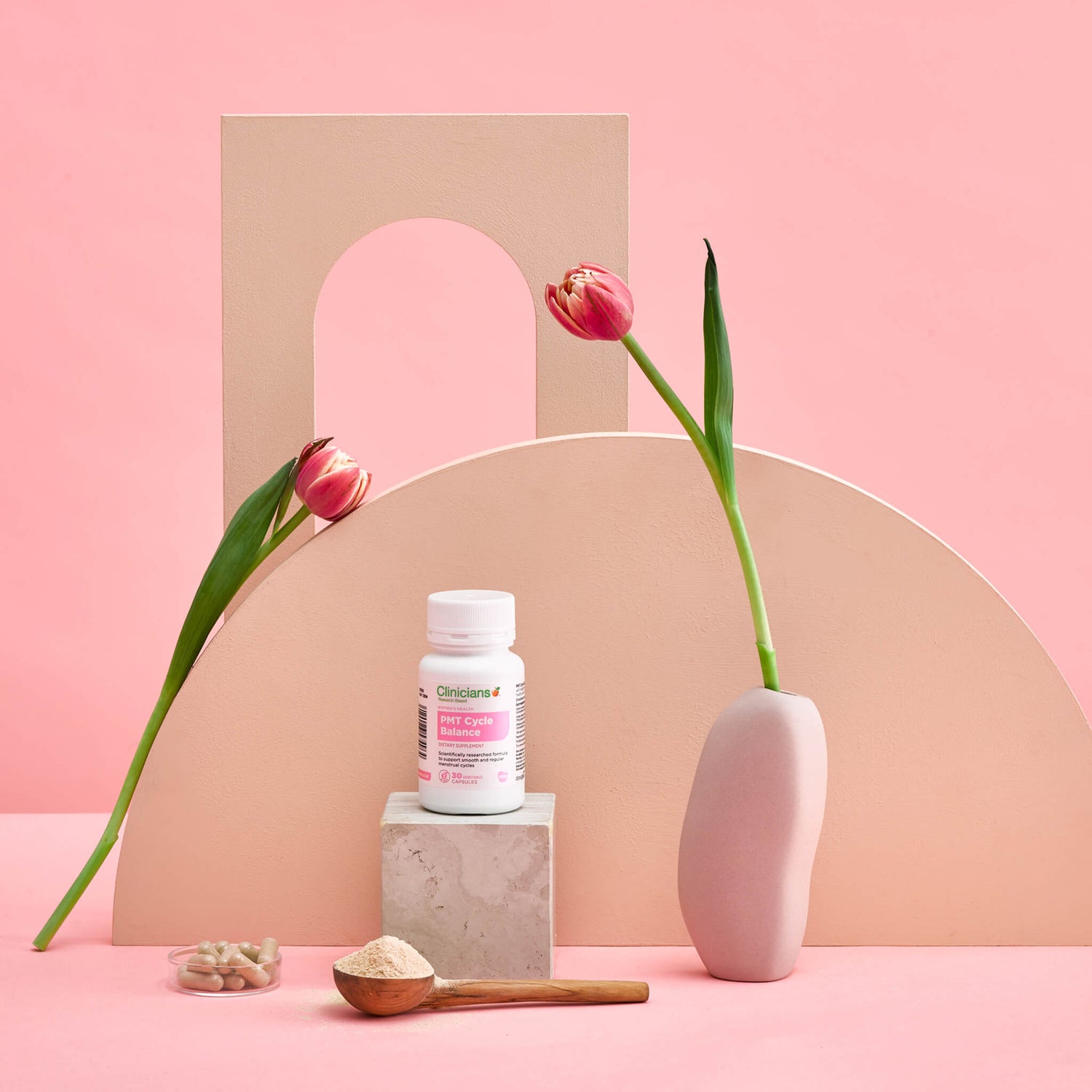 Bottle of PMT Cycle surrounded by flowers