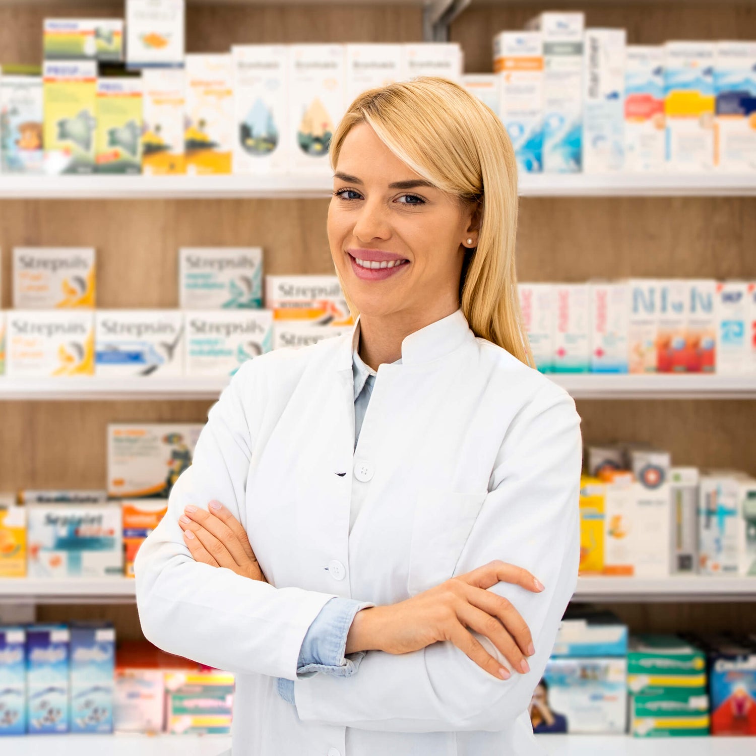 Female pharmacist standing in front of shelves of products