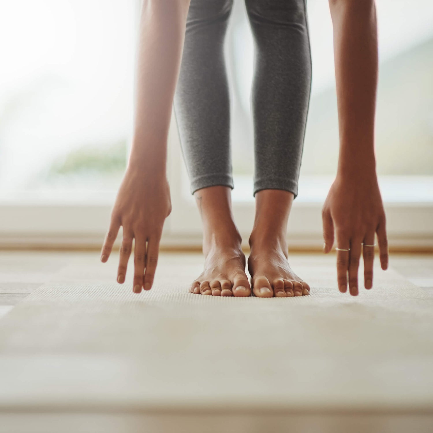 Women stretching her hands to touch her toes