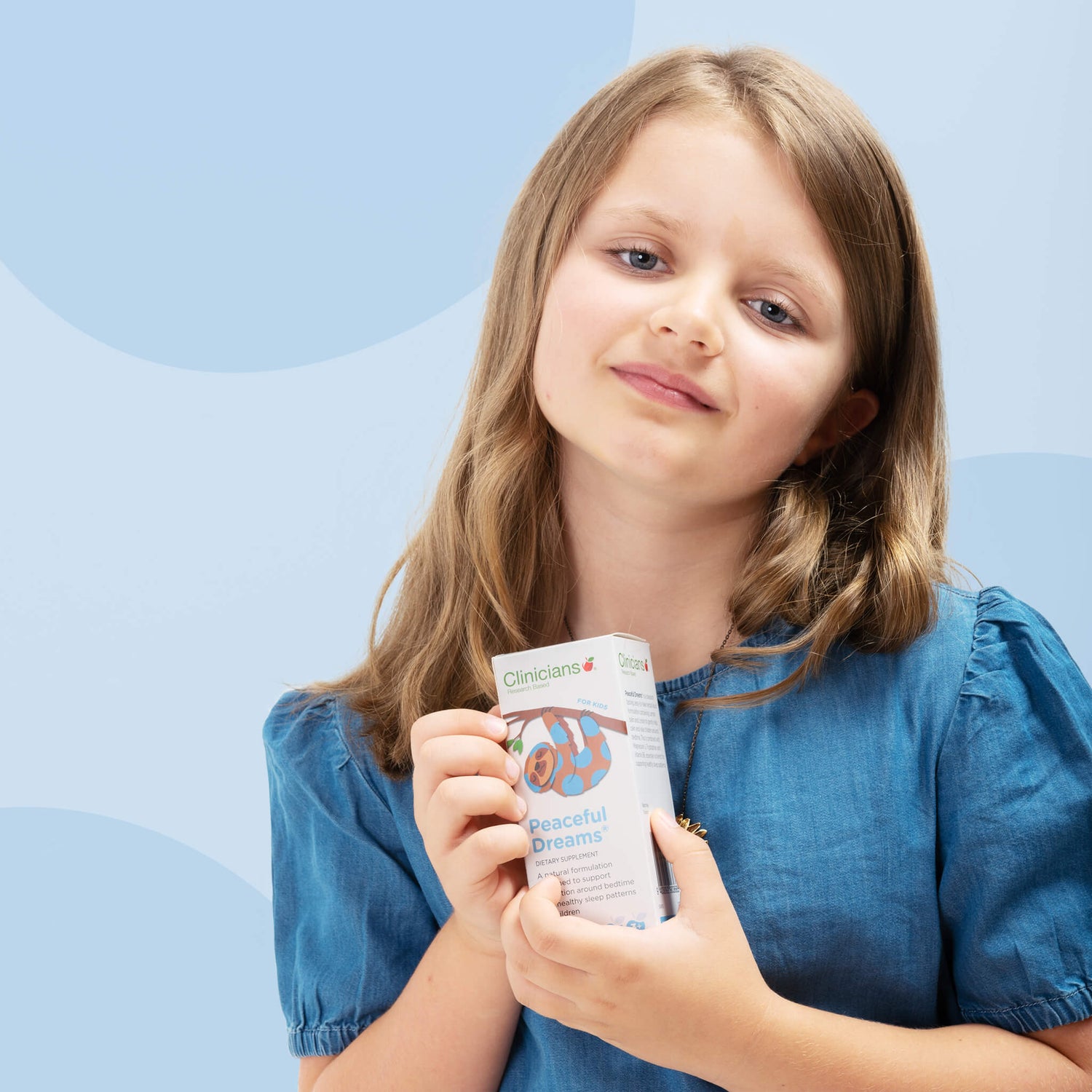 Child holding a box of Clinicians Peaceful Dreams
