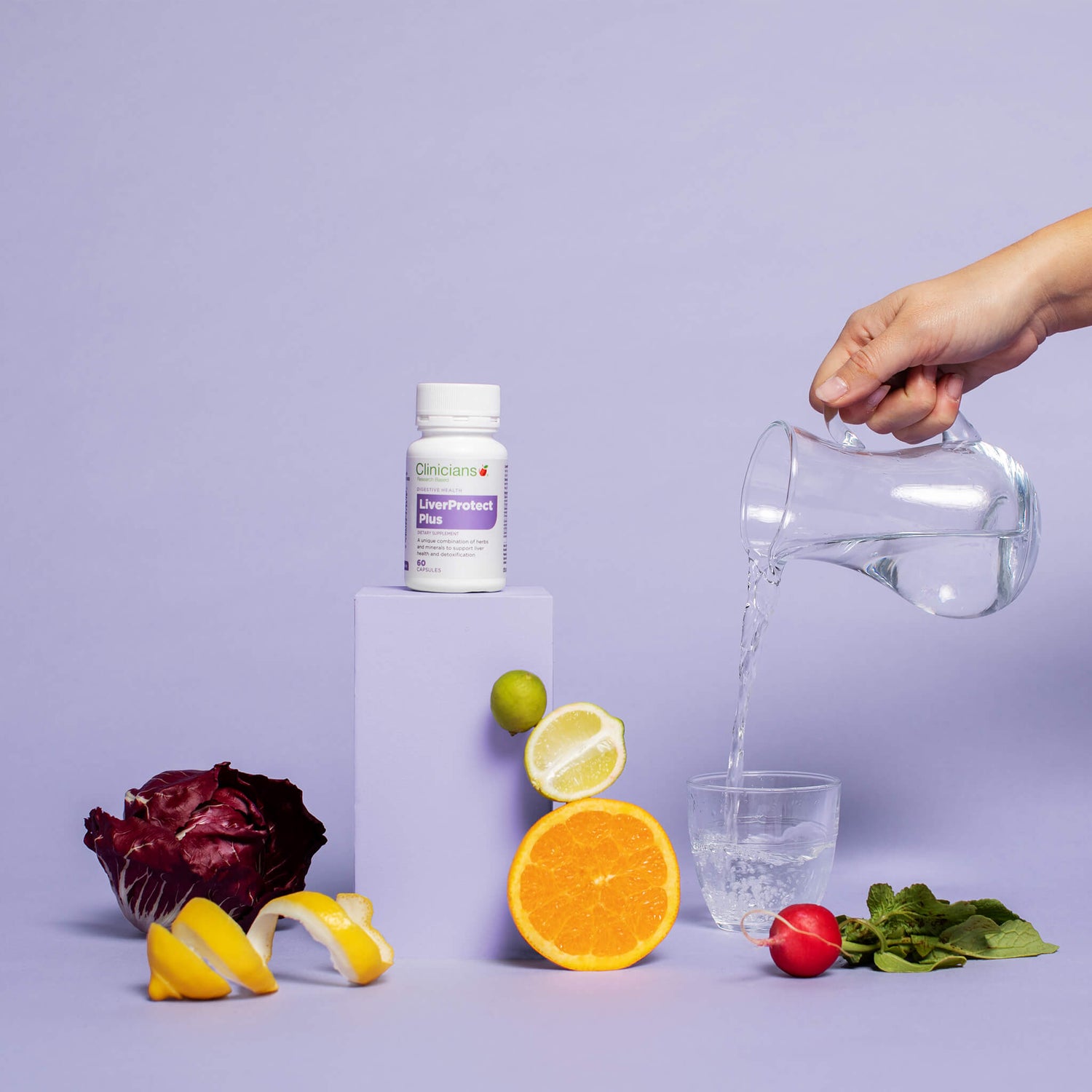 Product packaging, surrounded by fruit and water pouring into glass